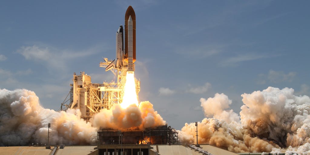 A conceptual image of a rocket launching into the sky, with the trail of smoke forming the words 'Affordable Pricing' in the clouds. This visually represents the idea of reaching new heights with Rocket Reach's pricing options.