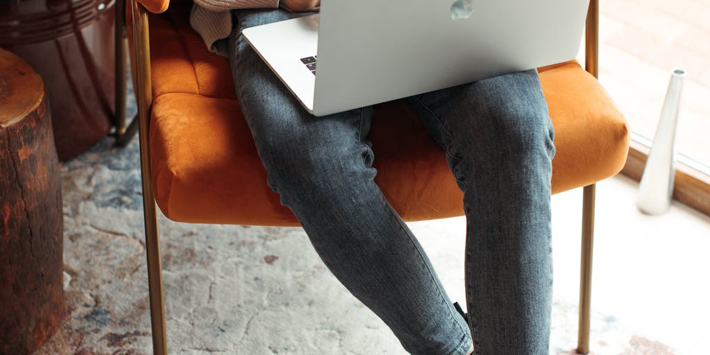 A person sitting at a desk, looking thoughtfully at their laptop screen where the Dripify interface is displayed. The lighting is warm and inviting, with a plant in the background to add a touch of nature, symbolizing growth and innovation.