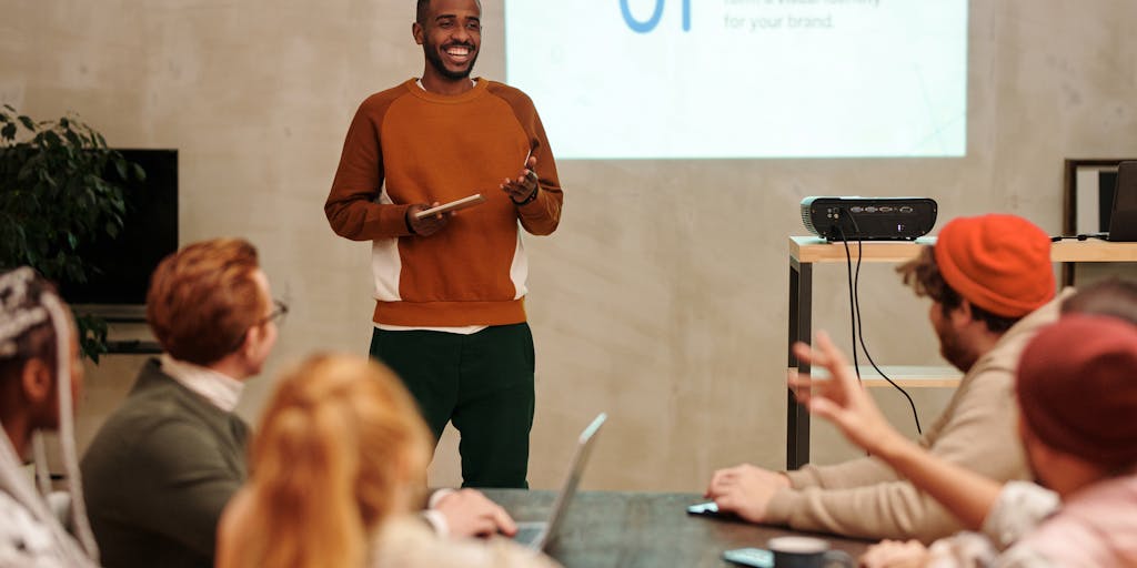 A close-up shot of a diverse group of people sitting in a modern office space, intently watching a presentation on a large screen. The screen displays colorful graphs and analytics related to audience engagement, symbolizing the concept of 'Audienceful Review'. The expressions on their faces reflect curiosity and engagement.