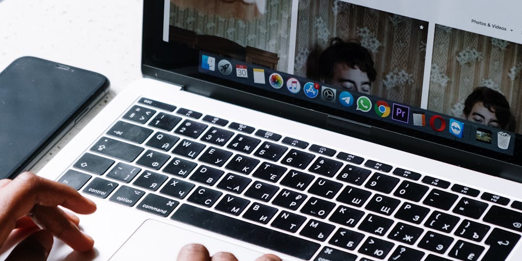 A person sitting at a café, typing on a laptop with a focused expression. The screen shows an email being composed with pricing information. The ambiance of the café, with people in the background, adds a casual yet professional vibe to the concept of emailing pricing instantly.