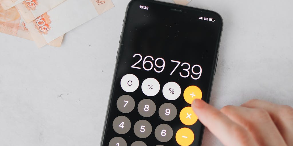 A creative flat lay of various currencies (dollars, euros, etc.) arranged around a printed AeroLeads pricing plan. Include a calculator and a notepad with handwritten notes about budgeting for lead generation, emphasizing the financial aspect of the service.