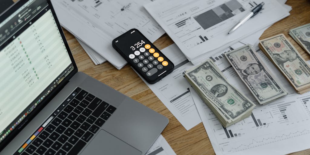 A creative flat lay of various coins and dollar bills arranged in the shape of a pie chart, with labels indicating different pricing plans. This visual metaphor highlights the concept of budgeting and investment in Buzzstream services.