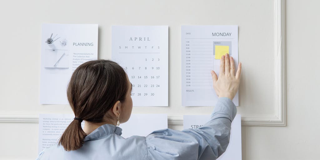 A dynamic shot of a team meeting in a modern office, with a whiteboard filled with pricing strategies and graphs. One team member is pointing at a section of the board while others take notes, capturing the collaborative effort in developing pricing models.