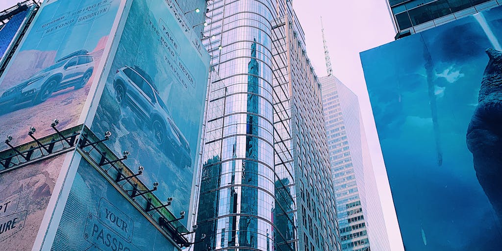 A futuristic city skyline at dusk, with digital billboards displaying real-time pricing updates. The scene captures the integration of technology and commerce, emphasizing the impact of Bardeen Pricing in urban environments.