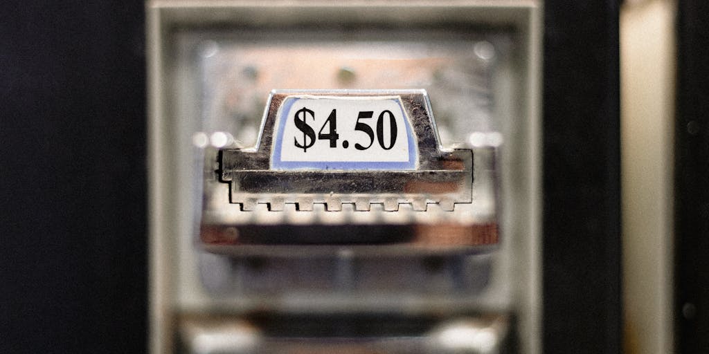 A close-up shot of a vintage scale balancing gold coins on one side and a modern digital pricing tag on the other, symbolizing the balance between traditional and modern pricing strategies.