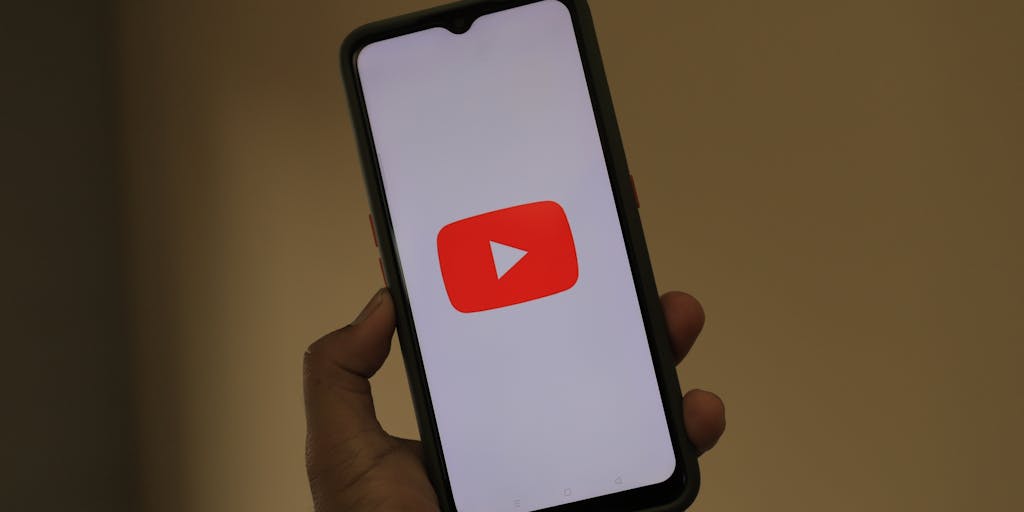 A conceptual image of a giant YouTube play button made of various marketing elements like social media icons, graphs, and video clips, symbolizing the integration of different marketing strategies to enhance YouTube presence. This visually represents the idea of a comprehensive YouTube marketing agency.