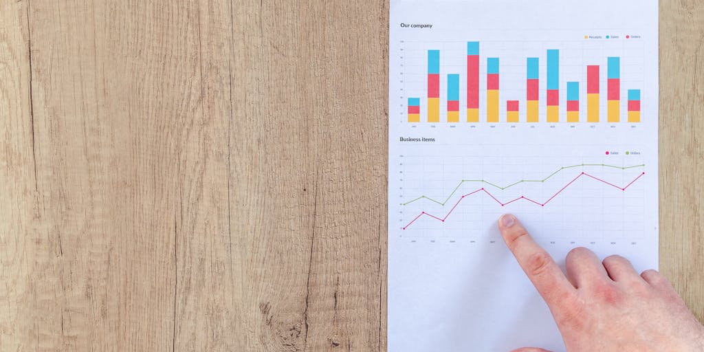 A close-up shot of a hand pinning a beautifully designed infographic on a corkboard, with various Pinterest boards in the background. The infographic should represent successful marketing strategies, emphasizing the visual appeal of Pinterest as a platform.