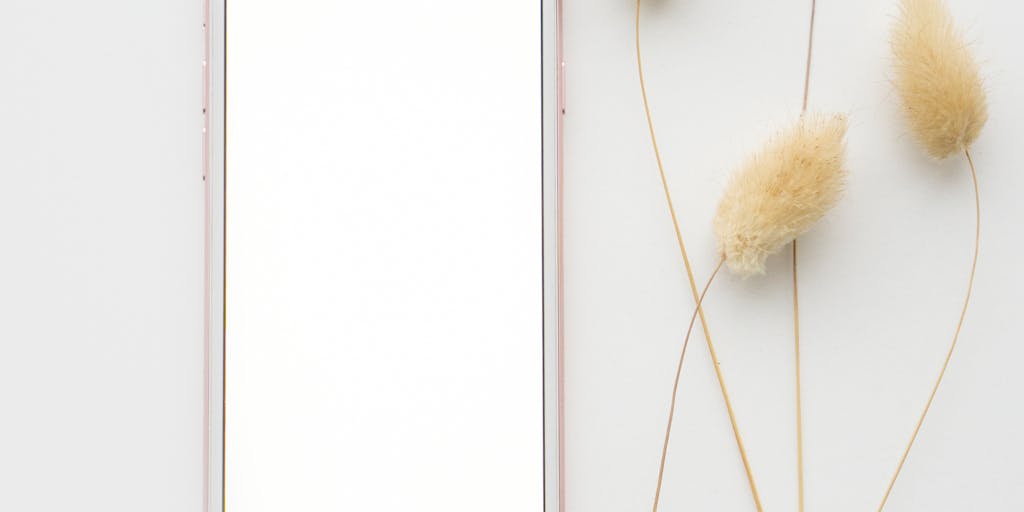 A creative flat lay of various mobile devices (smartphones and tablets) showcasing different mobile ad formats (videos, banners, interactive ads). The background should be colorful and modern, representing the innovative nature of mobile advertising agencies.