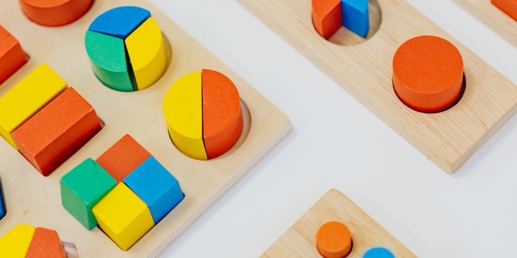 An overhead shot of a dining table filled with children's toys, school supplies, and a calculator, symbolizing the costs associated with raising two kids. The scene should evoke a sense of budgeting and planning for child support.