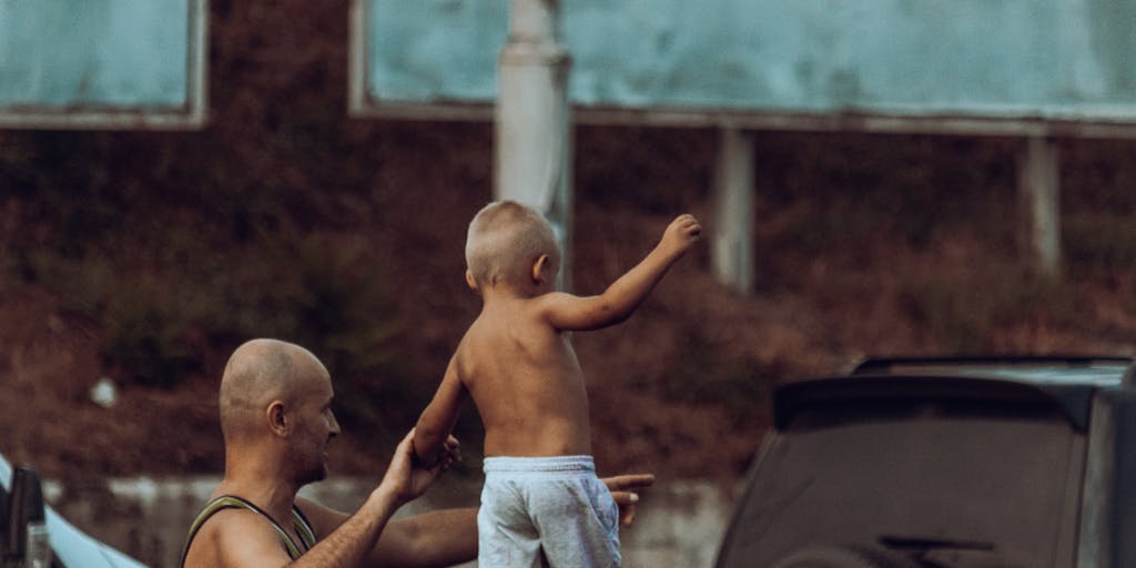 A conceptual photo of a road sign that reads 'Child Support Ahead' with a fork in the road, one path leading to a courtroom and the other to a happy family scene. This symbolizes the choices and consequences related to child support.