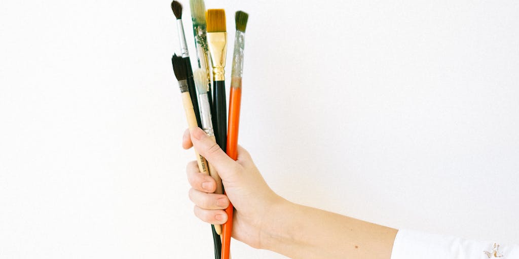 A creative flat lay of various items that child support does not cover, such as sports equipment, art supplies, and extracurricular activity flyers, arranged artistically on a table. This image can visually communicate the additional costs of raising a child beyond basic support.
