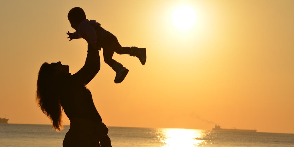 A split image showing two contrasting scenes: on one side, a parent happily playing with their child, and on the other side, a police officer holding a warrant. This juxtaposition highlights the emotional impact of child support issues.