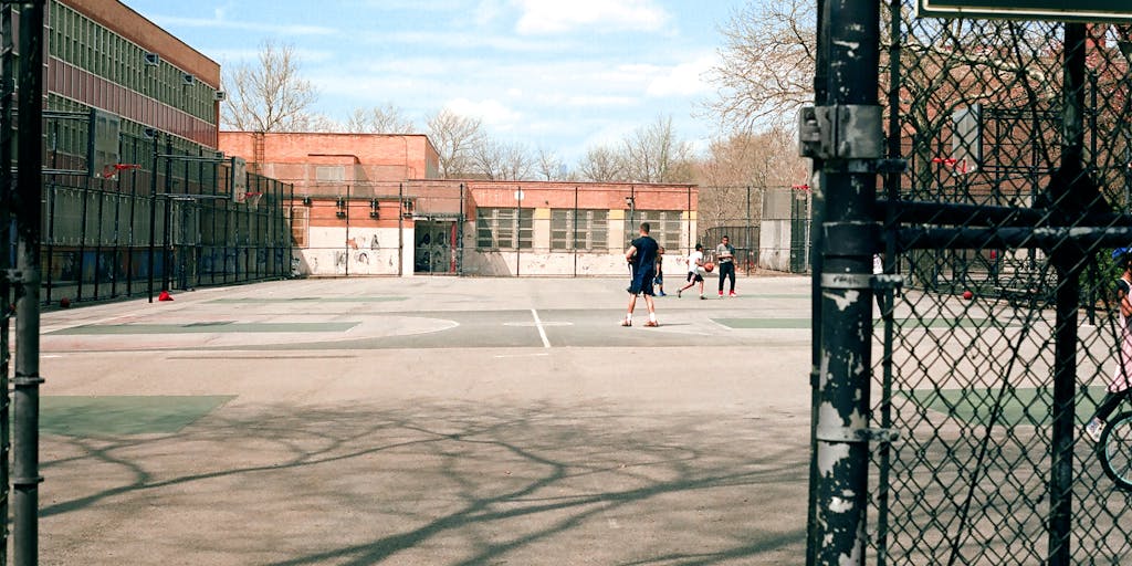 A visual metaphor of a broken chain link, symbolizing the end of child support obligations. The chain is set against a backdrop of a sunny park where children are playing, representing freedom and new beginnings.