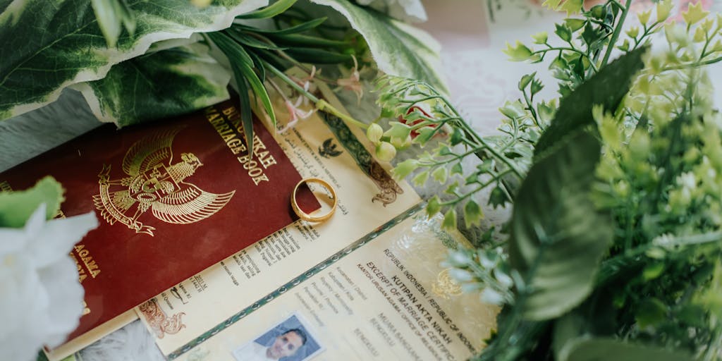 A close-up shot of a wedding ring resting on a stack of legal documents, including child support agreements. The ring symbolizes love and commitment, while the documents represent the financial responsibilities that come with marrying someone who has children from a previous relationship.