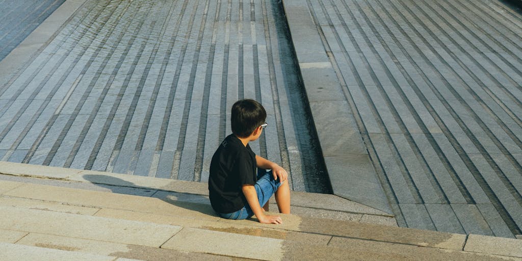 A split image showing two parents in a park with their children, each parent holding a sign that says 'Joint Custody' on one side and 'Child Support' on the other. The children are playing happily in the background, symbolizing the positive aspects of shared parenting.