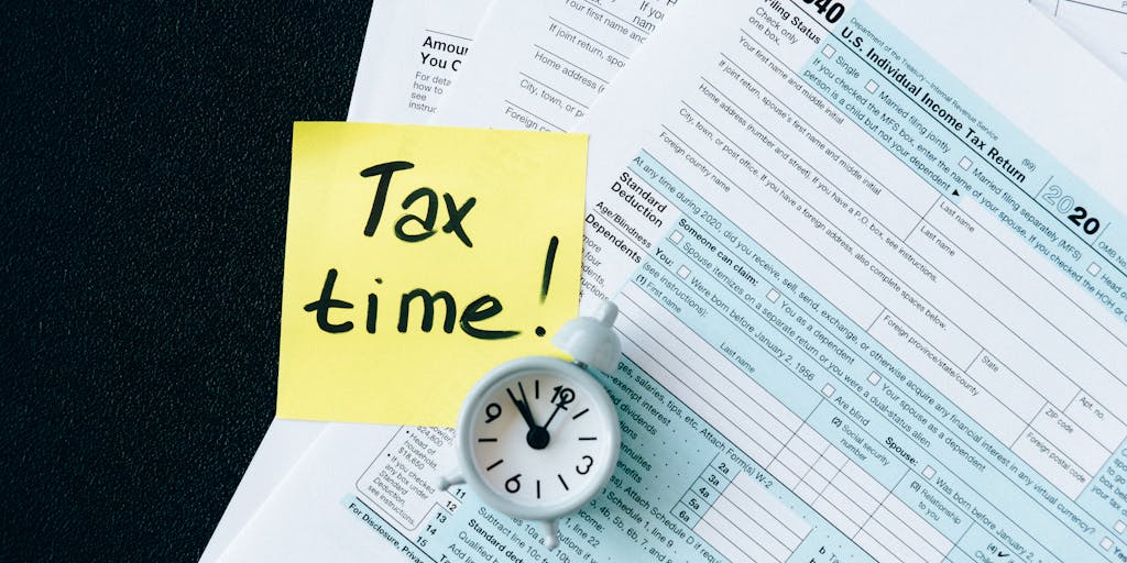A close-up shot of a hand holding a tax form with a sticky note that reads 'Can I claim them?' next to a photo of a smiling child. This image captures the uncertainty and questions parents may have regarding tax claims and child support.