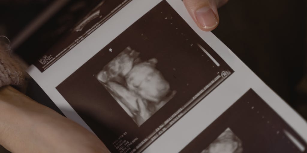 A split image showing two contrasting scenes: one side depicts a parent happily playing with their child, while the other side shows the same parent looking stressed and checking their phone for updates on child support. This visual contrast highlights the emotional rollercoaster of the process.