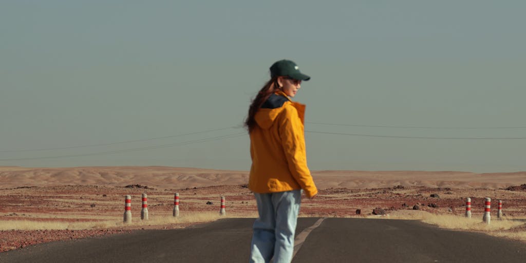 A visual metaphor of a long road stretching into the distance, with road signs indicating various milestones related to the child support process. The road should symbolize the journey and the time it takes to reach the destination of receiving support.