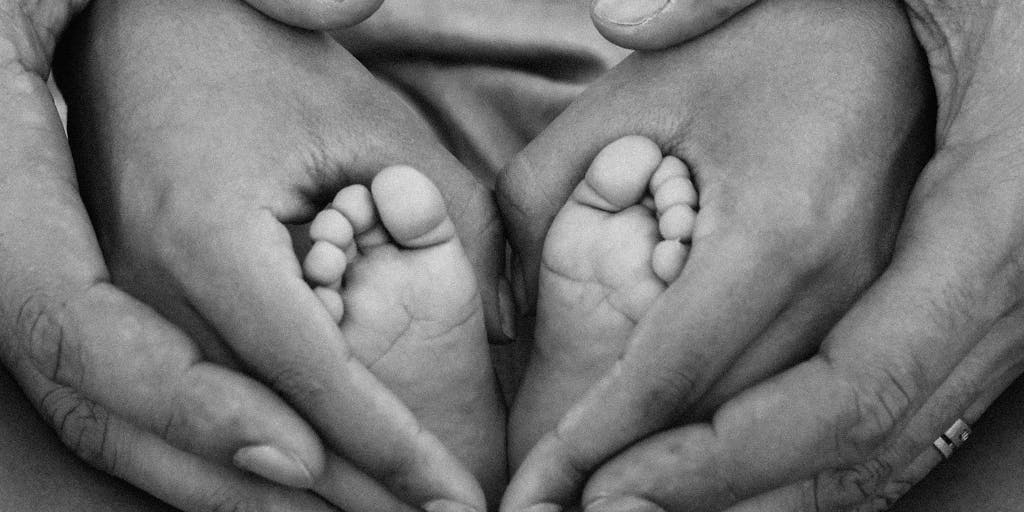 A conceptual image of a scale balancing a dollar sign and a heart, with a mother and child in the background, representing the emotional and financial aspects of child support in California.