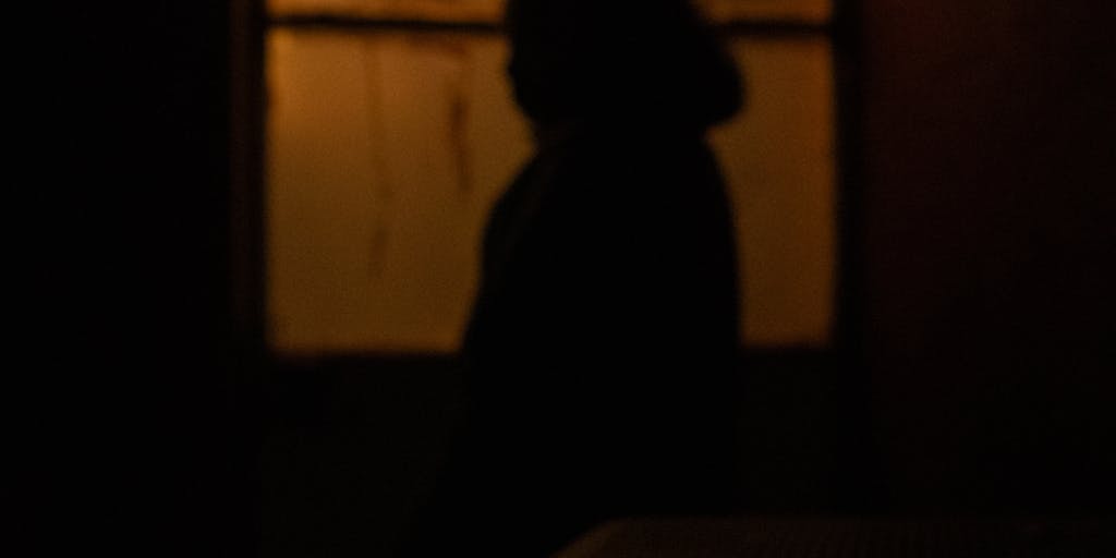 A conceptual photo of a clock with its hands stuck at 5 o'clock, symbolizing the feeling of time standing still while waiting for a child support payment. In the background, a parent is seen pacing or looking at their watch, conveying anxiety about the delay.