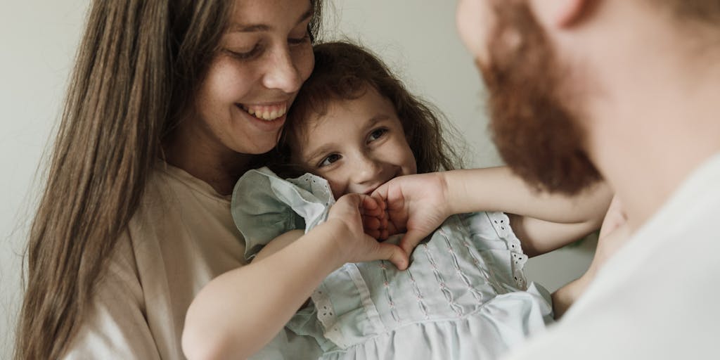 An artistic representation of a scale balancing a heart and a dollar sign, symbolizing the emotional and financial aspects of child support. The background can be a soft-focus image of a family home.