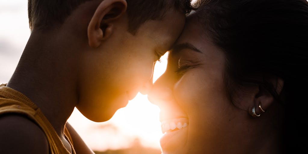A split image showing two contrasting scenes: on one side, a parent happily playing with their child, and on the other side, a worried parent looking at overdue bills. This visual contrast highlights the emotional and financial stakes involved in child support.