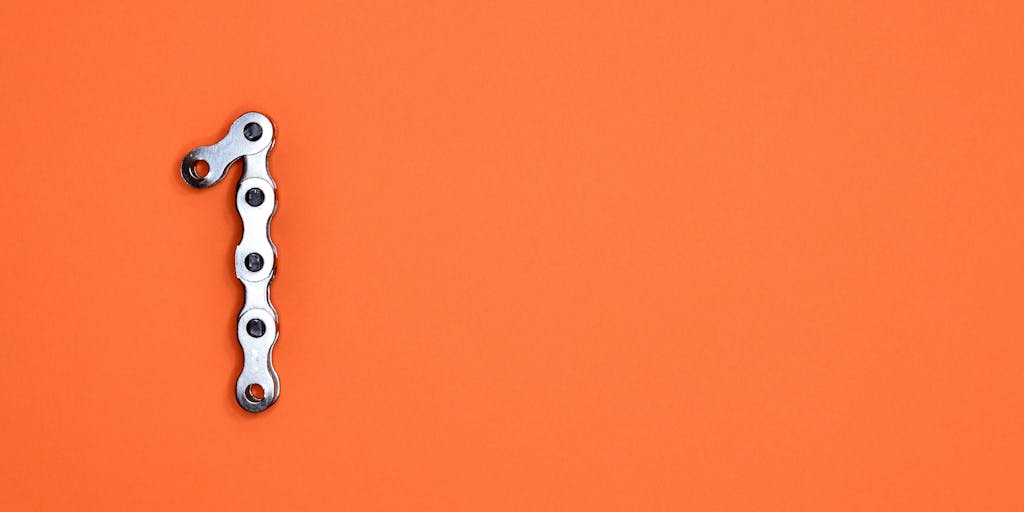A conceptual photo of a broken chain symbolizing the release from financial obligations. The chain links are rusted and breaking apart, representing the dismissal of child support arrears. The background is a soft-focus image of a child playing, highlighting the positive outcome for families.