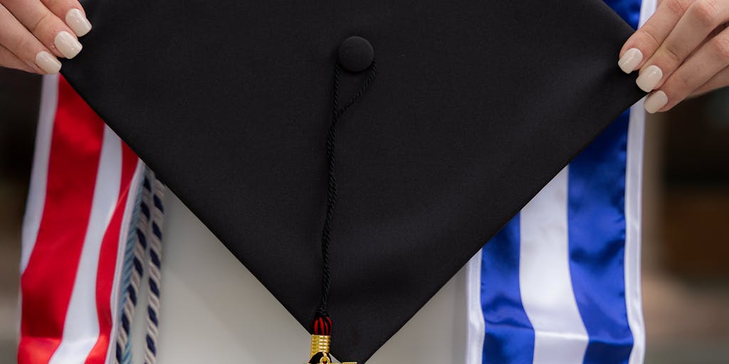 A conceptual image of a scale balancing a graduation cap on one side and a stack of bills on the other. This visual metaphor represents the balance between educational achievements and financial responsibilities as child support ends.