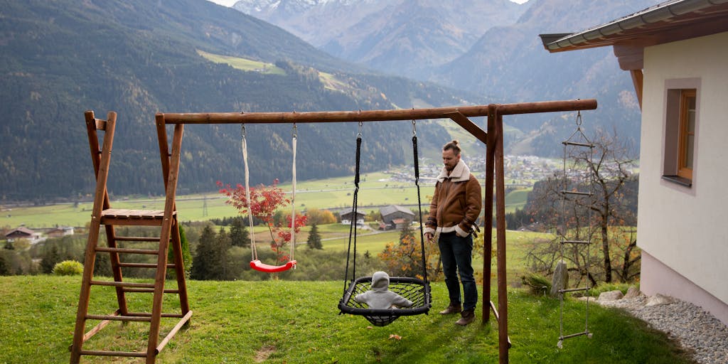 A conceptual image of a father standing at a crossroads, with one path leading to a courtroom and the other to a playground. This visual metaphor represents the choices and challenges fathers face regarding child support and visitation rights.