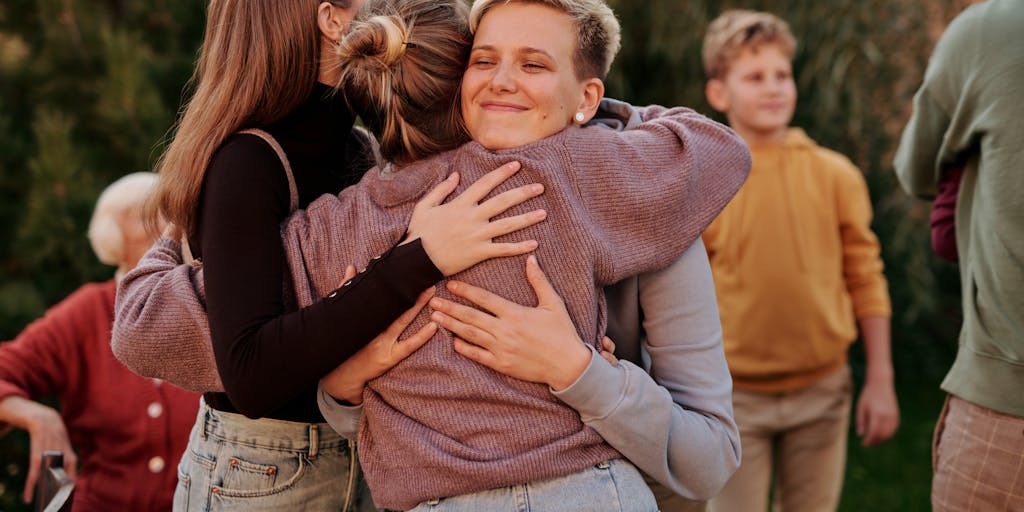 A candid moment of a group of women sitting in a support group, sharing their experiences about child support. The image should capture the warmth and solidarity among them, with expressions of empathy and understanding, showcasing the community aspect of navigating child support issues.