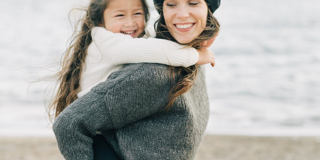 A split image showing two different households: one with a single parent happily engaging in activities with their children, and the other showing a parent calculating finances at a table. This visual contrast highlights the emotional and financial aspects of child support.