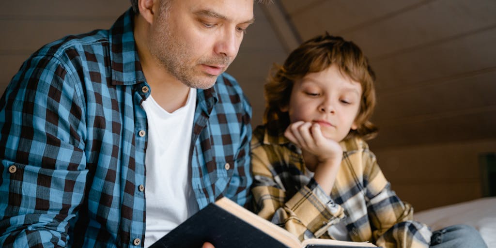 A candid photograph of a parent and child engaged in a fun educational activity, like reading together or doing a science experiment. The image captures the essence of how child support enables parents to invest time and resources into their child's learning and development.