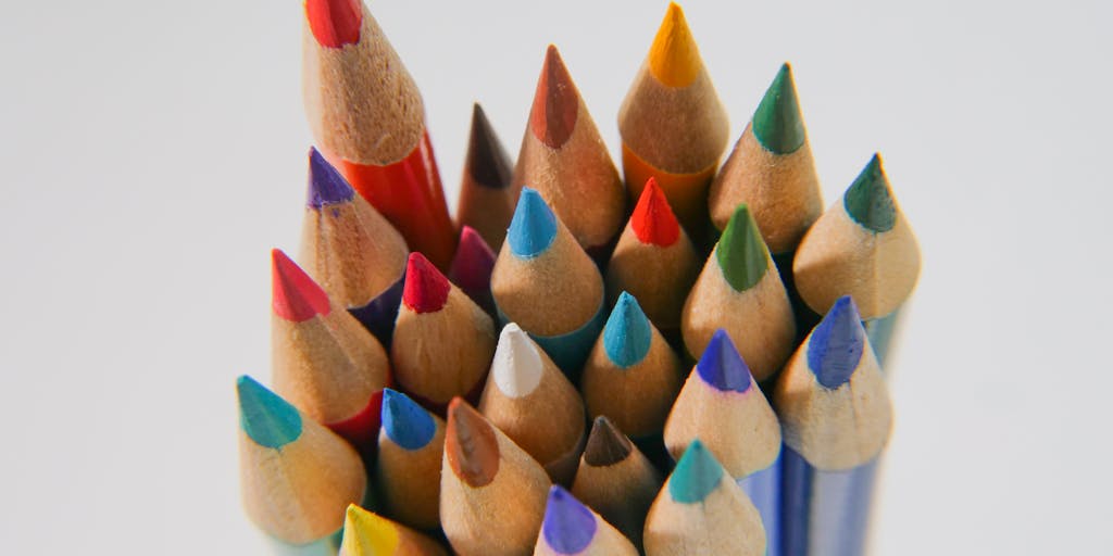 A close-up shot of a child's hands holding a report card with good grades, surrounded by school supplies like notebooks, pencils, and a backpack. This image symbolizes the role of child support in facilitating a child's academic success and the resources needed for their education.