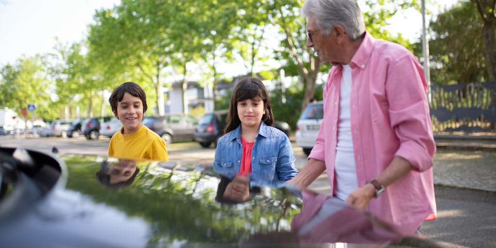 A joyful reunion scene in a park where a parent and child embrace, symbolizing the relief and happiness that comes with the resolution of child support arrears. The background features vibrant greenery and a sunny sky, emphasizing a fresh start.