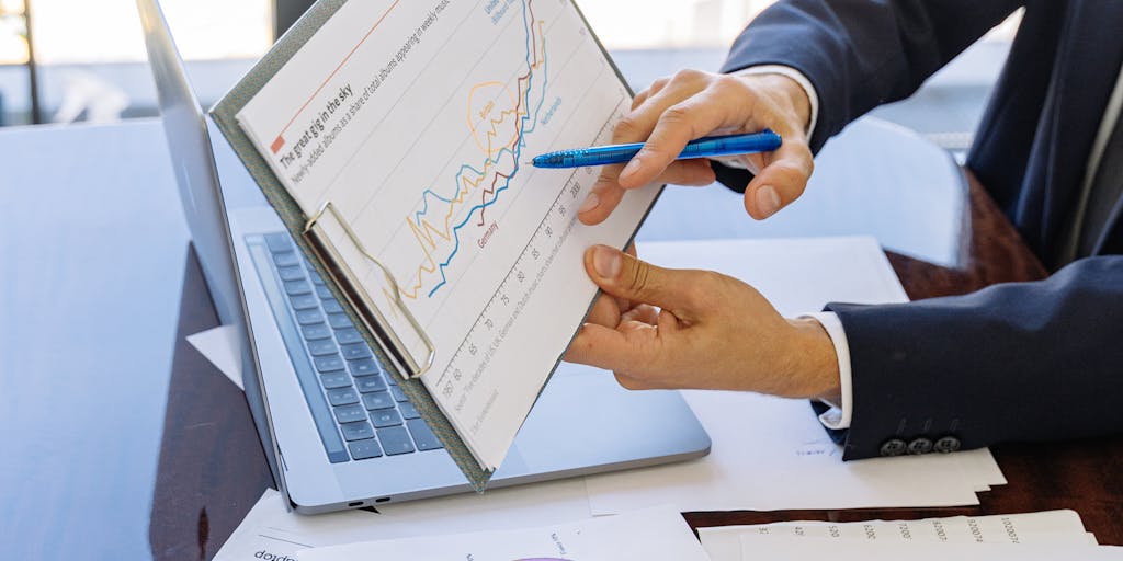 An image of a family sitting together at a table, discussing finances. The table is cluttered with papers, including a child support agreement and a calculator, illustrating the complexities of financial responsibilities as children grow older.