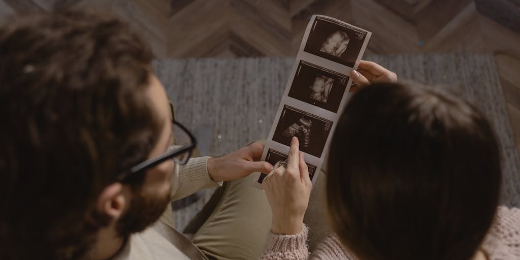 A split image showing two scenarios: on one side, the couple is happily living together, and on the other side, they are in a courtroom setting discussing child support. This juxtaposition highlights the contrast between their personal life and legal obligations.