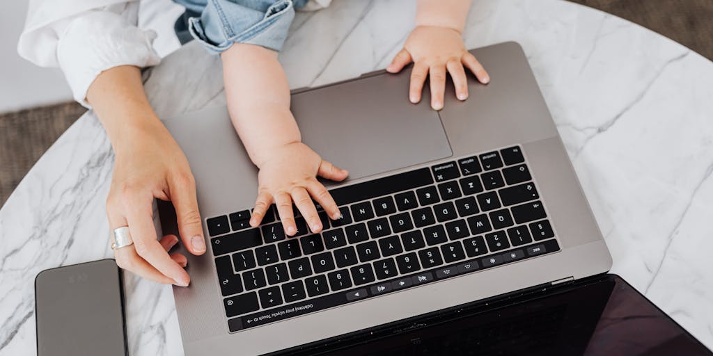 A close-up shot of a parent sitting at a desk, surrounded by paperwork and a laptop, looking focused and determined. The desk is cluttered with documents labeled 'Child Support Application' and a cup of coffee, symbolizing the seriousness of the task at hand.
