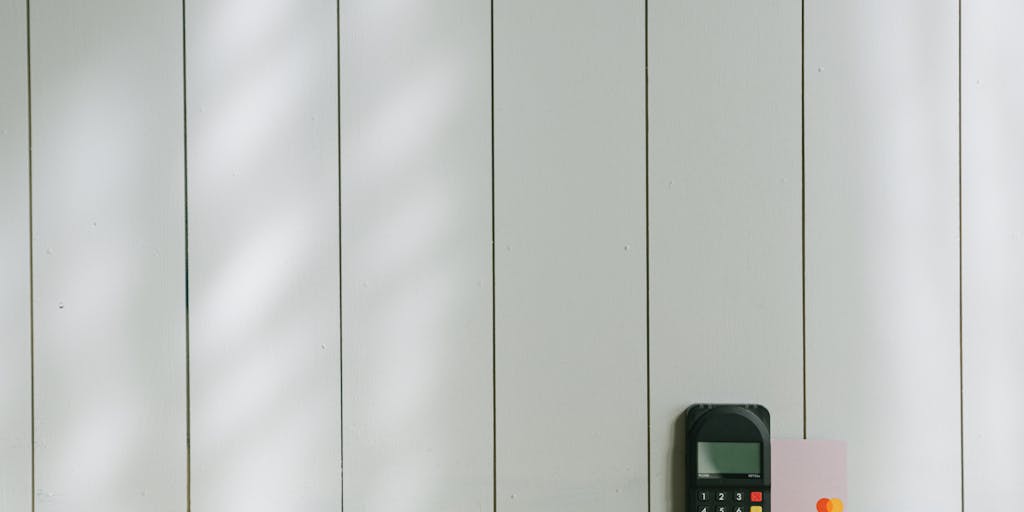 A conceptual image of a bank account icon encased in ice, with dollar bills and coins trapped inside. The background features a clock, symbolizing the time aspect of how long child support can affect finances.