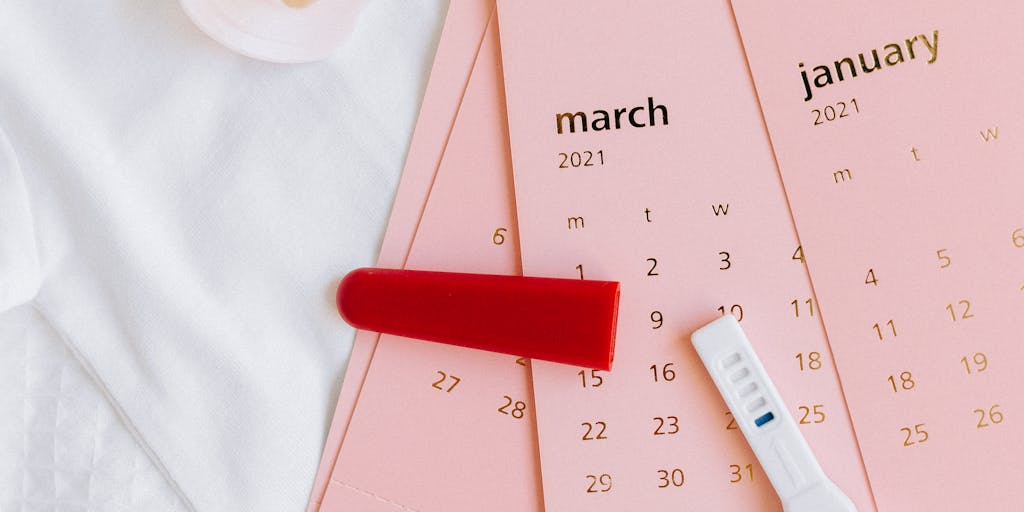A close-up shot of a calendar page with marked dates indicating milestones like 'first day of school', 'turning 18', and 'graduation'. The calendar is surrounded by items representing childhood and adulthood, illustrating the timeline of child support.