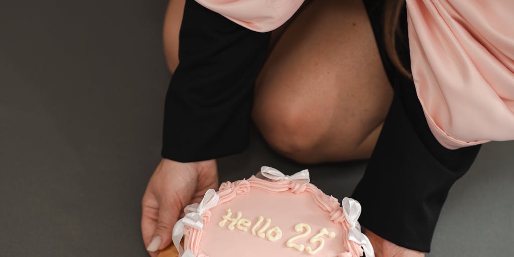 A warm, candid moment of a young adult celebrating their birthday with family, holding a card that symbolizes financial independence. The atmosphere is joyful, highlighting the transition from childhood to adulthood and the implications of receiving child support directly.