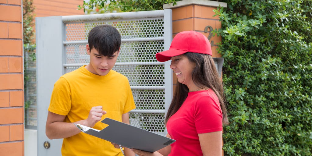 An artistic shot of a child support payment check being handed over to a teenager in a park, with a blurred background of trees and sunlight filtering through. This image represents the concept of direct payments and the growing independence of the child.