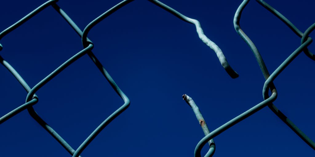 An artistic representation of a broken chain symbolizing the release from child support liens. The chain is depicted in the foreground, while a bright, sunny sky is in the background, representing hope and new beginnings.