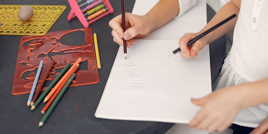 A close-up shot of a mother’s hands holding a calculator and a child’s drawing, symbolizing the balance between financial responsibilities and nurturing creativity. The background is softly blurred to emphasize the contrast between numbers and art.